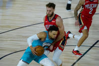 Memphis Grizzlies' Dillon Brooks (24) tries to get past New Orleans Pelicans' Nicolo Melli (20) during the first half of an NBA basketball game Monday, Aug. 3, 2020 in Lake Buena Vista, Fla. (AP Photo/Ashley Landis, Pool)