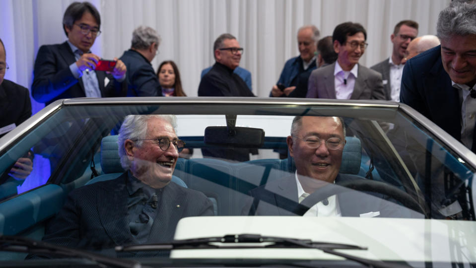 Designer Giorgetto Giugiaro (left) sits inside the recreated Hyundai Pony Coupé Concept with Euisun Chung, the executive chair of Hyundai Motor Group.