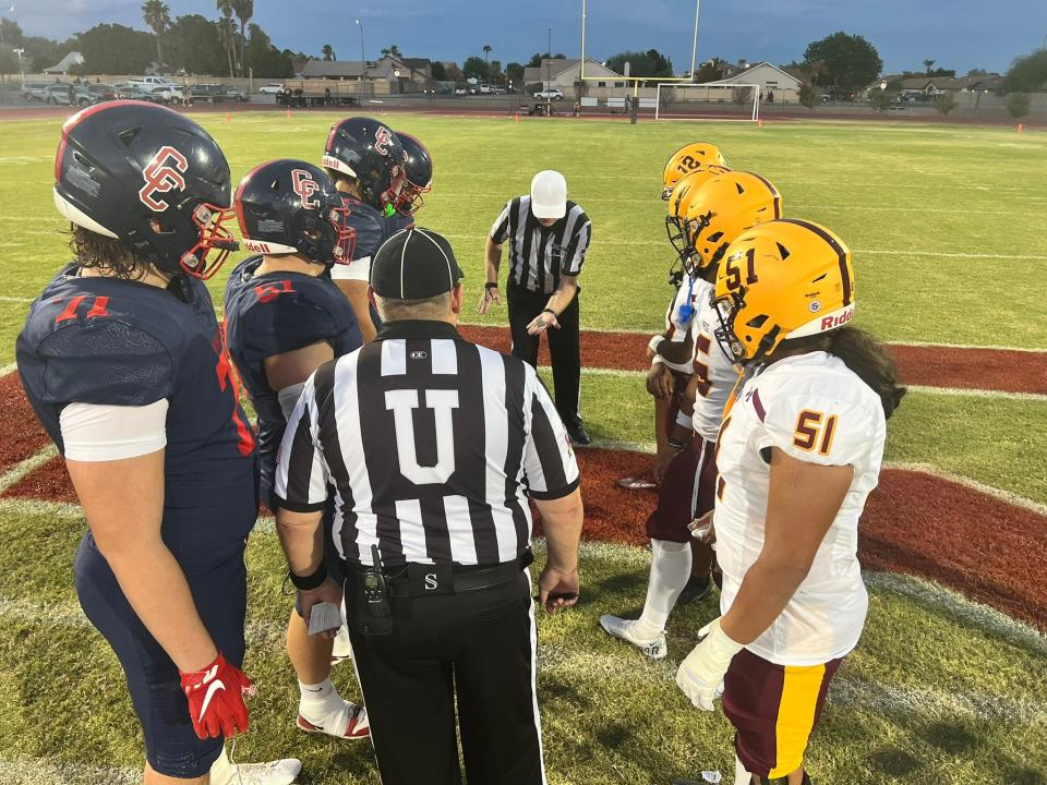 Players from Centennial (left) and Mountain Pointe take midfield for the pregame coin toss ahead of their  Friday game at Centennial High School in Peoria. Sept. 8, 2023.