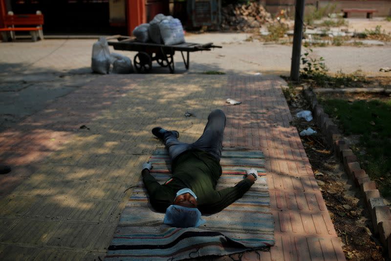 Ashish Kashyap rests after collecting unclaimed ashes of the victims who died from the coronavirus disease (COVID-19), at a crematorium in New Delhi