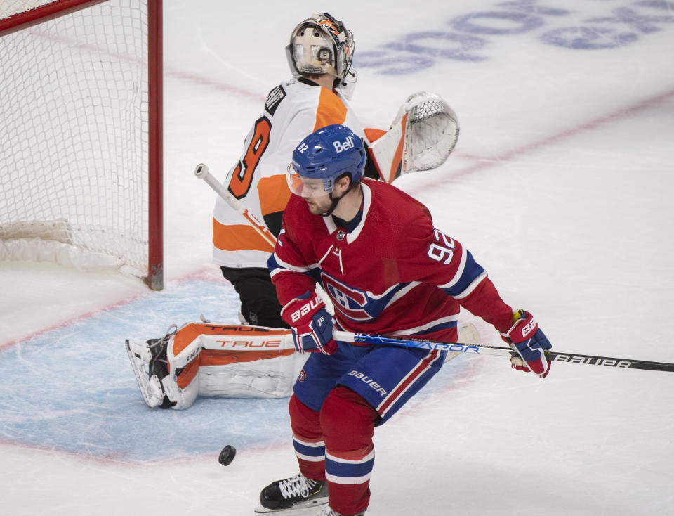 Montreal Canadiens' Jonathan Drouin scores against Philadelphia Flyers goaltender Carter Hart during a shootout at a NHL hockey game in Montreal, Thursday, Dec. 16, 2021. (Graham Hughes/The Canadian Press via AP)