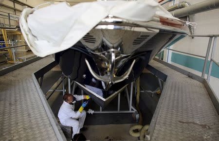 An employee works on a yacht at the Ferretti's shipyard in Sarnico, northern Italy, April 7, 2015. REUTERS/Stefano Rellandini