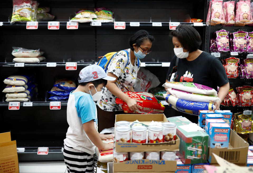 People stock up on rice after Singapore raised the coronavirus outbreak alert level to orange, at a supermarket in Singapore February 8, 2020. REUTERS/Edgar Su