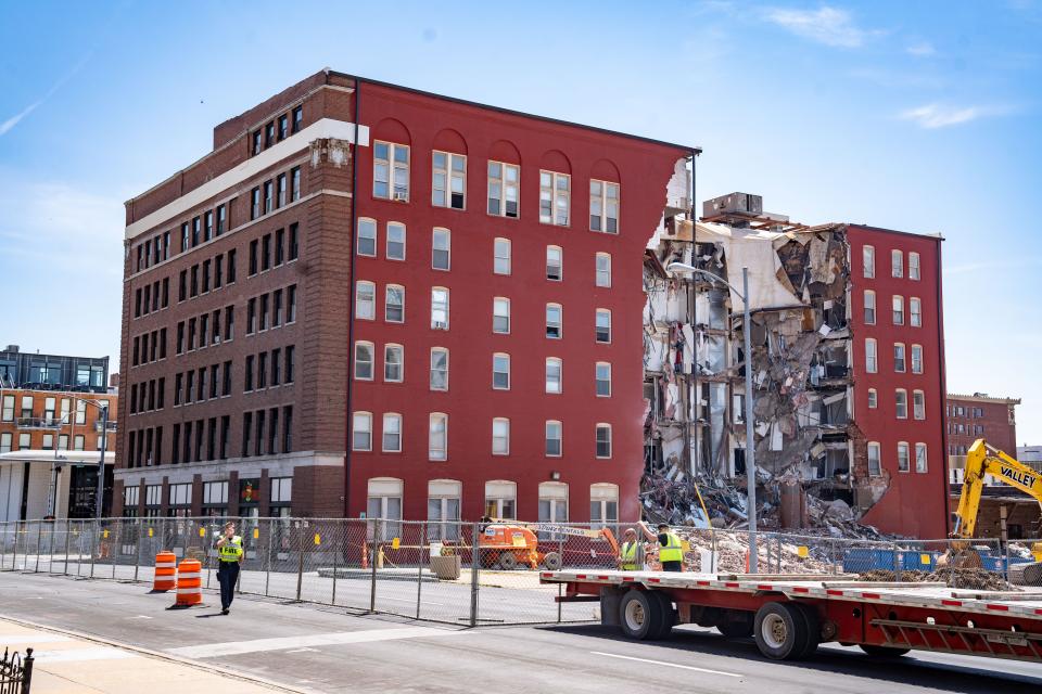 Workers secure the area on Monday, May 29, 2023, a day after an apartment building partially collapsed in Davenport.