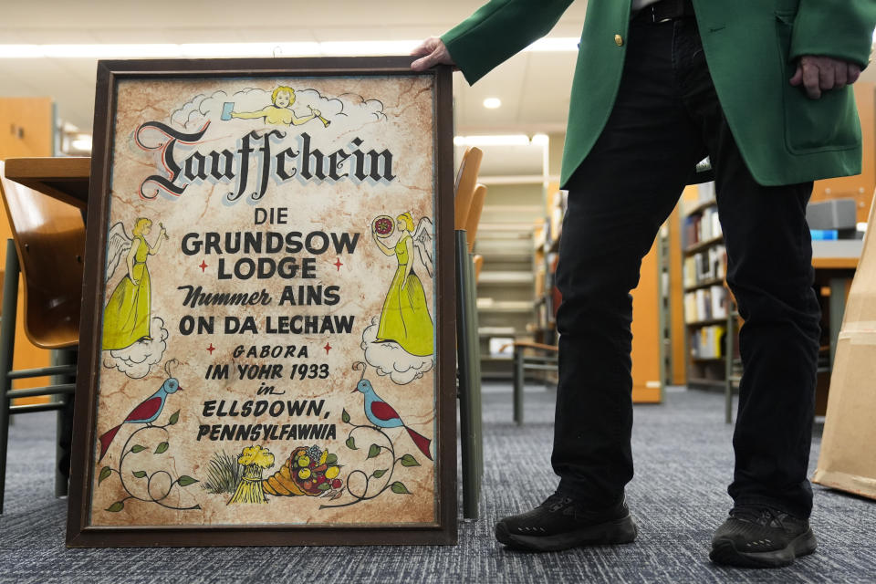 Kutztown University anthropology professor William W. Donner displays a Groundhog Lodge's birth certificate during an interview in Kutztown, Pa., Monday, Jan. 29, 2024. These lodges began as a way to preserve and celebrate Pennsylvania Dutch culture and traditions. (AP Photo/Matt Rourke)