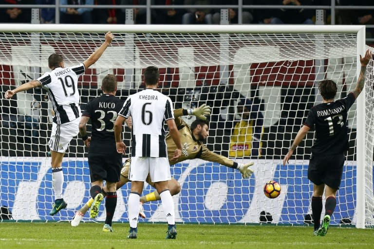 AC Milan's goalkeeper Gianluigi Donnarumma reaches for the ball during the match against Juventus on October 22, 2016 at the San Siro Stadium in Milan