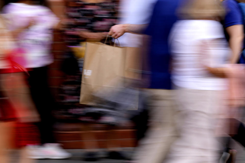 Shoppers walks through London's biggest shopping street, Oxford Street, in London, Thursday, Aug. 4, 2022. The Bank of England has projected that the United Kingdom's economy will enter a recession at the end of the year. To tame accelerating inflation driven by the fallout from Russia's war in Ukraine, the bank hiked interest rates Thursday by the largest amount in more than 27 years. (AP Photo/Frank Augstein)