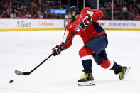 Washington Capitals left wing Alex Ovechkin (8) shoots the puck during the first period of an NHL hockey game against the Detroit Red Wings, Tuesday, March 26, 2024, in Washington. (AP Photo/Nick Wass)