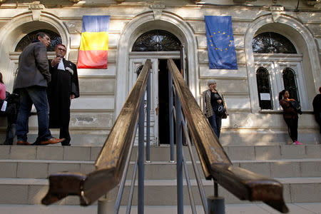 FILE PHOTO: People stand outside the court building where the trial of suspects in the theft of seven paintings from a Dutch museum last year, is taking place in Bucharest October 22, 2013. REUTERS/Bogdan Cristel/File Photo