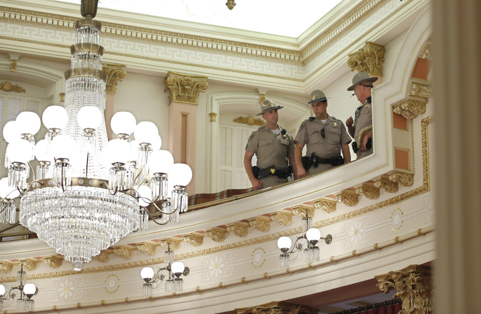 California Highway Patrol Officers inspect the Senate Gallery after a red substance was thrown from the gallery during the Senate session at the Capitol in Sacramento, Calif., Friday, Sept. 13, 2019. The Senate was cleared as an investigation is taking place. Authorities took a person into custody.(AP Photo/Rich Pedroncelli)