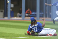 Toronto Blue Jays first baseman Vladimir Guerrero Jr. is unable to make a play on a pop double by Baltimore Orioles' Ryan McKenna during the first inning of a baseball game Monday, Aug. 15, 2022, in Toronto. (Jon Blacker/The Canadian Press via AP)