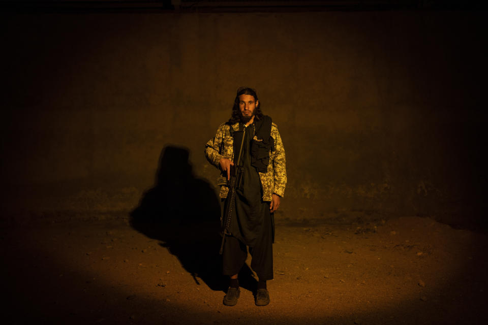 A Taliban fighter poses for a photo at a check point in Herat Afghanistan, on Saturday, Nov. 27, 2021. Since the Taliban's takeover of Afghanistan just over three months ago amid a chaotic withdrawal of U.S. and NATO troops, its fighters have changed roles, turning from fighting in the mountains and the fields to running the country. (AP Photo/ Petros Giannakouris)