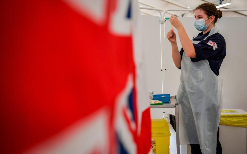 Royal Navy personnel prepare to give Covid jabs to the public at a vaccination centre set up at Bath Racecourse - Ben Birchall/PA