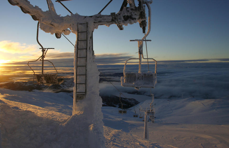 FILE - In this Feb. 11, 2007 file photo, the sun rises as ice encrusted chair lifts make their way prior to the Men's Downhill, at the World Alpine Ski Championships in Are, Sweden. Even the world's top skiers can struggle to keep warm in extremely cold conditions, which will likely be a factor at the Alpine world championships opening in Are, Sweden, next week, from 5–17 February 2019. (AP Photo/Sergey Ponomarev, file)