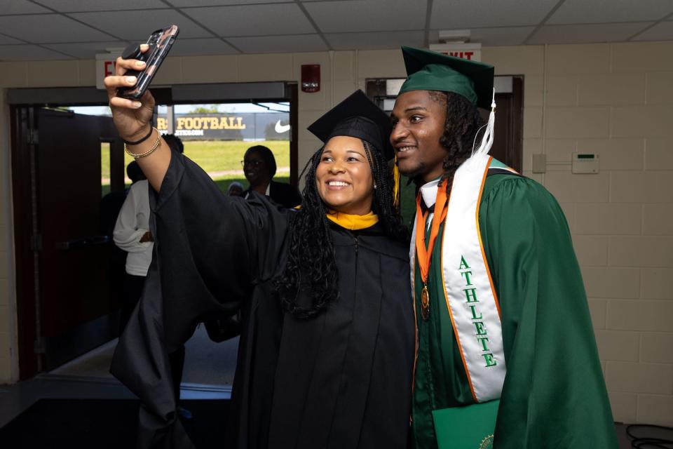 Florida A&M vice president and director of athletics Tiffani-Dawn Sykes (left) takes a selfie with football star Isaiah Land (right) after he graduated Bachelors of Science in Interdisciplinary Studies at the Al Lawson Multipurpose Center in Tallahassee, Florida, Saturday, May 6, 2023. Land now plays in the NFL for the Indianapolis Colts.