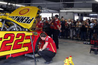 Fans watch the crew for Joey Logano in the new garage facilities during practice for the NASCAR Cup Series auto race at Talladega Superspeedway, Saturday, Oct 12, 2019, in Talladega, Ala. (AP Photo/Butch Dill)
