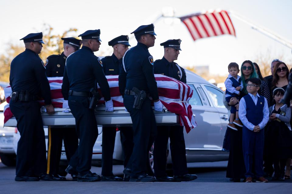 Officer Jonah Hernandez's widow, Yesenia, and their sons, Joaquin and Sebastian, watch as the casket with the body of the slain Las Cruces Police Department officer is carried inside Abundant Church in El Paso, Texas, on Wednesday, Feb. 21, 2024.