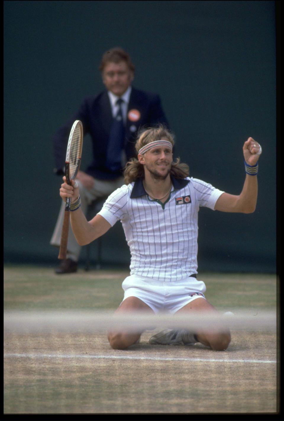 Bjorn Borg falls to his knees after winning the 1979 Wimbledon championship. He's wearing his iconic pin-striped Fila shirt with the blue collar.