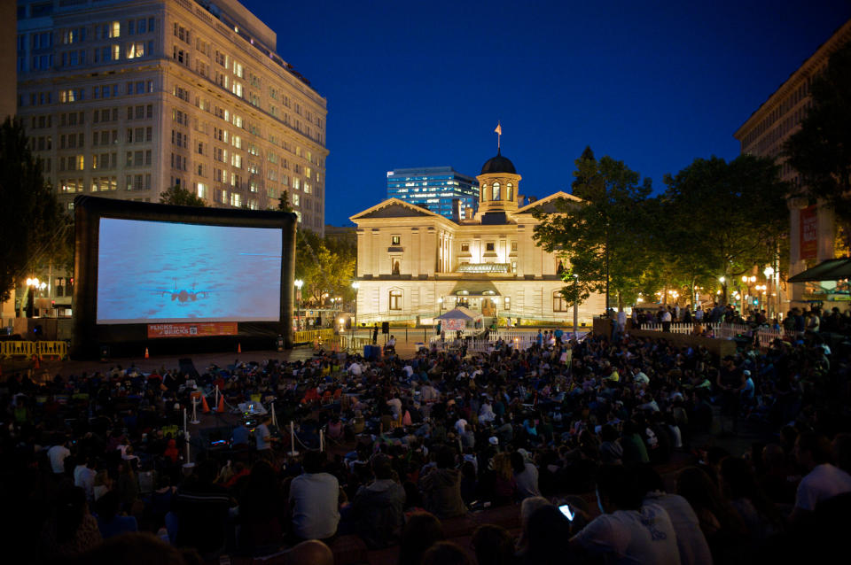 This undated image provided by Travel Portland shows the Pioneer Courthouse in Portland, Ore., lit up at night during a free movie screening event called Flicks on the Bricks. The courthouse building dates to 1869, is the oldest federal building in the Pacific Northwest and is one of a number of free things to see in Portland, which has a long history connected to the Old West despite its reputation as something of a funky hipster town. The movie festival will be held this summer on four Friday evenings, July 26 through Aug. 16. (AP Photo/www.travelportland.com, Torsten Kjellstrand)
