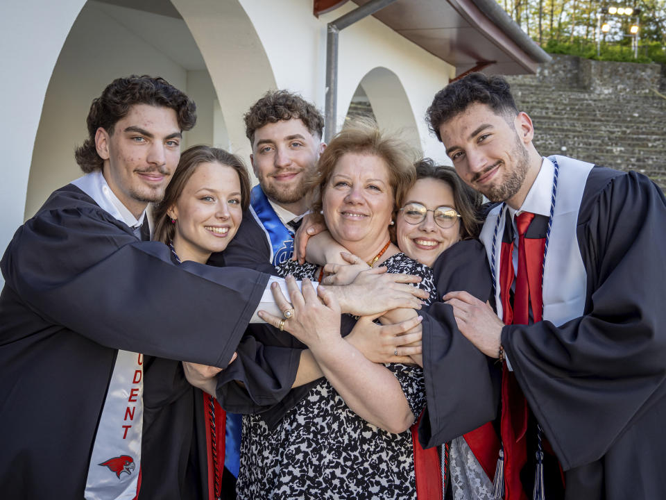 The Povolos quintuplets, from left; Michael, Victoria, Ludovico, Ashley and Marcus pose with their mother Silvia Povolo for a photo before the commencement ceremony at the Montclair State University, Monday, May 13, 2024, in Montclair, N.J. (Mike Peters/Montclair State University via AP)