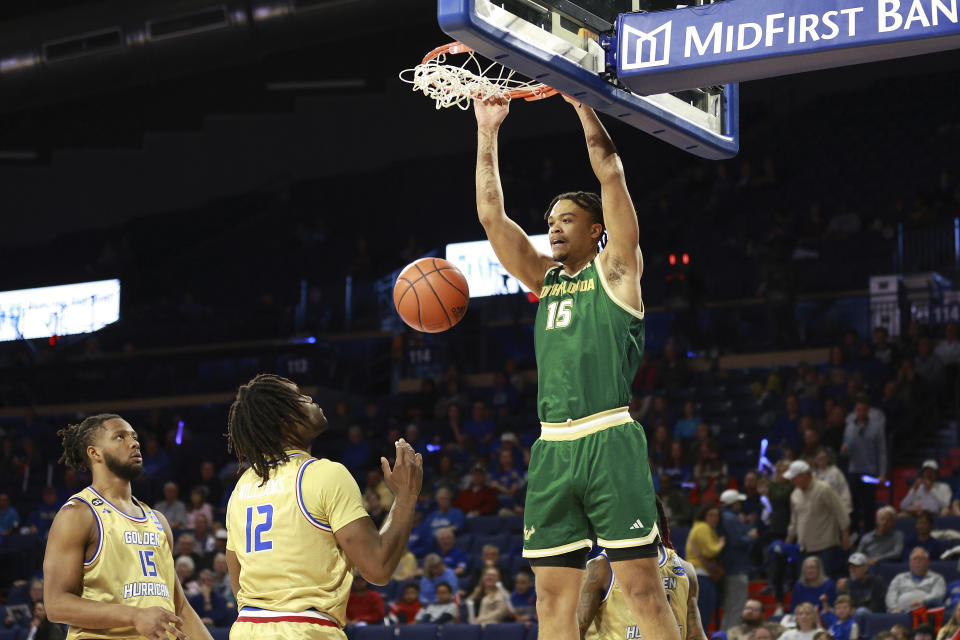 South Florida forward Corey Walker Jr. (15) dunks against Tulsa during the first half of an NCAA college basketball game, Saturday, March 9, 2024, in Tulsa, Okla. (AP Photo/Joey Johnson)