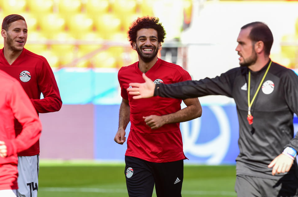 <p>All smiles: Salah appears to have shaken off the shoulder injury he sustained in the Champions’ League Final – although he was named on the bench for Egypt’s opening fixture. (Rex) </p>