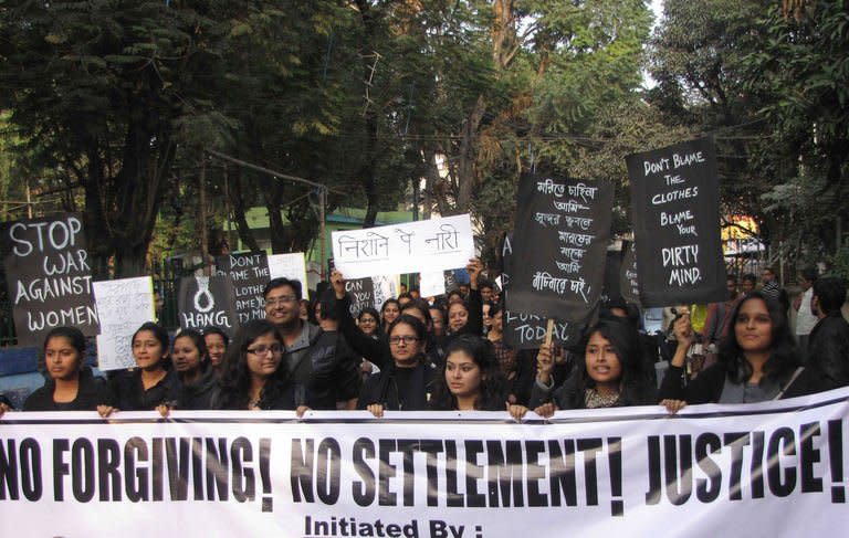 Indian youths hold placards as they take part in protest following the gang rape of a student last week in the Indian capital during a rally in Siliguri on December 22, 2012