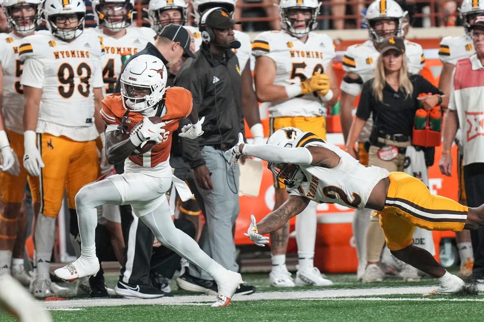 Texas wide receiver Xavier Worthy evades Wyoming defensive back Wrook Brown's tackle attempt during the Longhorns' win Sept. 16. Texas, now No. 3 in the country, will host No. 24 Kansas on Saturday at Royal-Memorial Stadium.