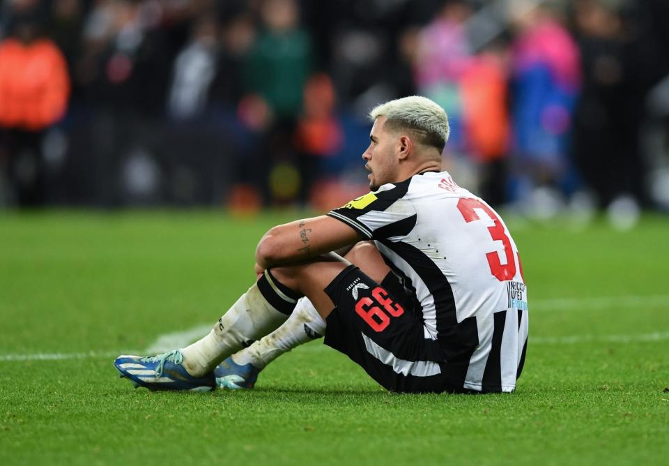 Bruno Guimaraes sits on the grass following Champions League defeat to AC Milan at St. James Park