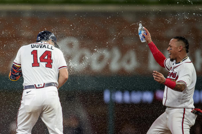 Atlanta Braves Orlando Arcia, right, throws water in celebration on Adam Duvall (14) in the ninth inning of a baseball game against the San Francisco Giants Wednesday, June 22, 2022, in Atlanta. (AP Photo/Hakim Wright Sr.)