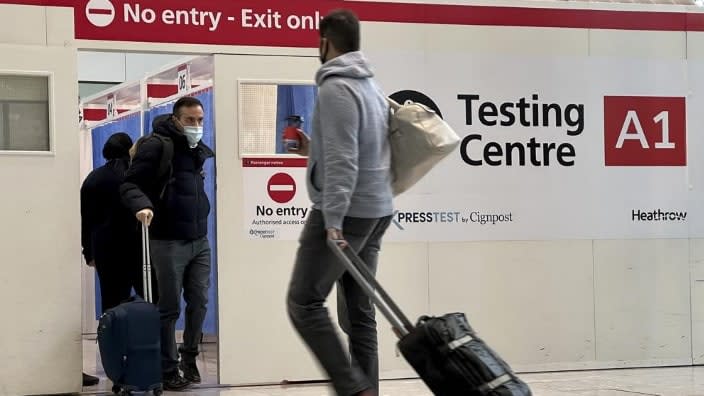 Passengers get a COVID-19 test at Heathrow Airport in London last November. The Biden administration is lifting its requirement that international air travelers to the U.S. take a COVID-19 test within a day before boarding their flights, easing one of the last remaining government mandates meant to contain the spread of the coronavirus. (Photo: Frank Augstein/AP, File)