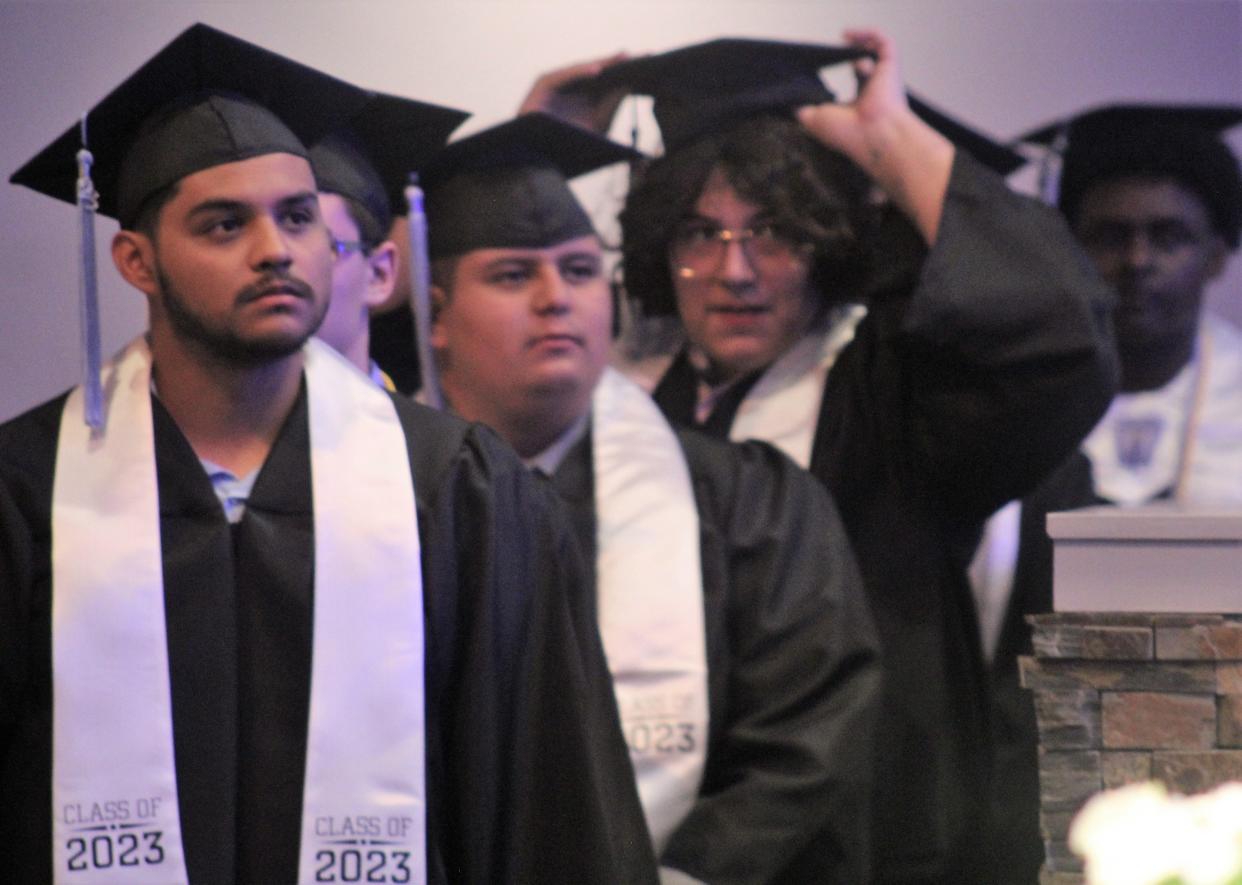 Kaiden Castillo, left, waits to be the first in the Class of 2023 to accept a diploma at Friday's graduation ceremony. There were eight in his senior class.