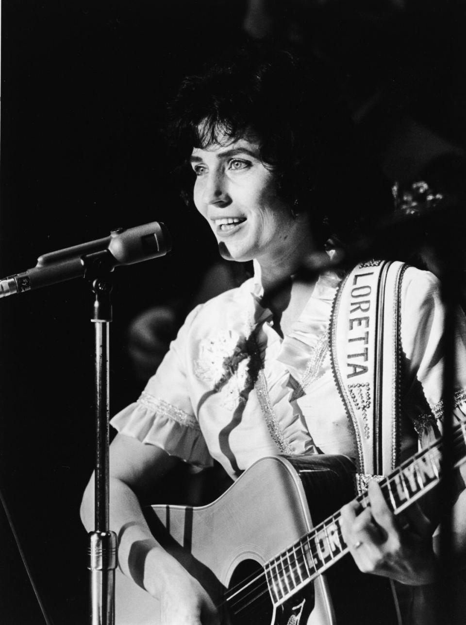 A female singer performs onstage in the 1960s.