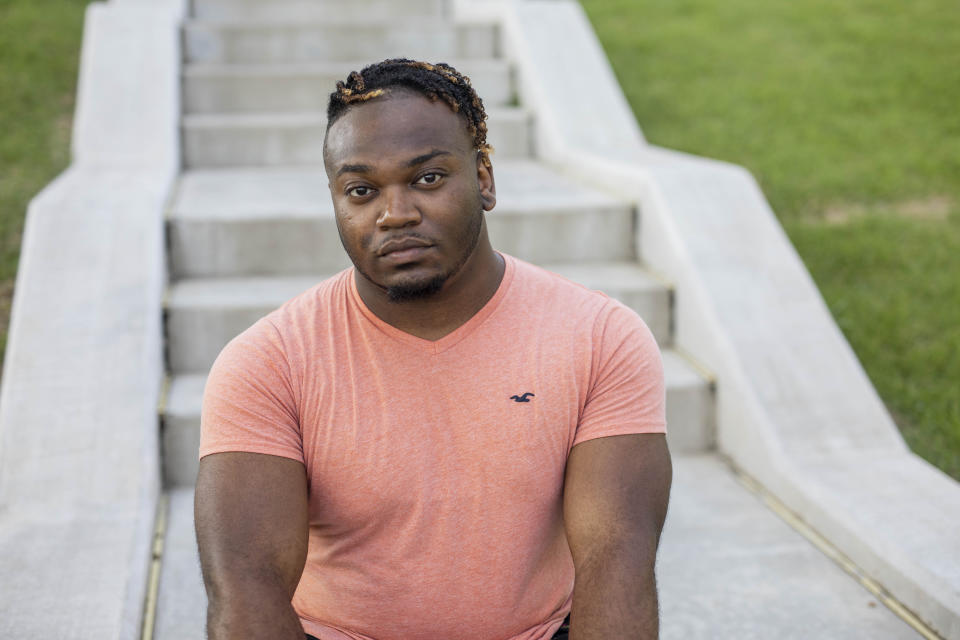 In this Saturday, July 20, 2019 photo, Sanjay Johnson poses for a photo, in Downtown Little Rock, Ark. Johnson was accused of exposing a sexual partner to HIV. Prosecutors in Little Rock pursued a criminal charge against Johnson even though a doctor said he couldn’t have transmitted HIV because he was on medication that suppressed his virus. In roughly 20 states, it’s a crime for people with HIV to have sex without first informing their partner of their infection. (AP Photo/Gareth Patterson)