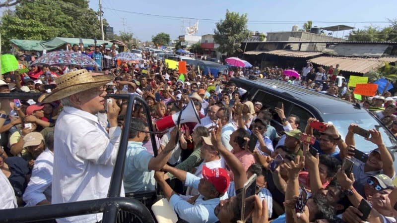 Mexico's President Andres Manuel Lopez Obrador uses a megaphone to talk to supporters during a rally in Ayutla de los Libres