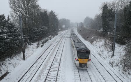 A Thameslink train passes through Harpenden in the snow, Harpenden, Britain, March 2, 2018. REUTERS/Peter Cziborra