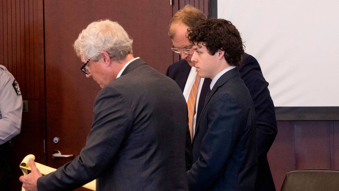 Landen Glass, right stands in court with his attorneys Robert Smith Jr., left, and Russell Babb during a bond hearing at the Wake County Justice Center in Raleigh. Glass is the driver who lost control of his truck and struck and killed an 11-year-old girl in the Raleigh Christmas parade. He faces felony involuntary manslaughter charge.