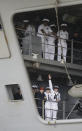 Sailors aboard the nuclear aircraft carrier Harry S. Truman wave to family and friends on the pier at Naval Station Norfolk in Norfolk, Va., Friday, April 18, 2014. The carrier Strike Group returned from a 9-month deployment to the Middle East. (AP Photo/Steve Helber)