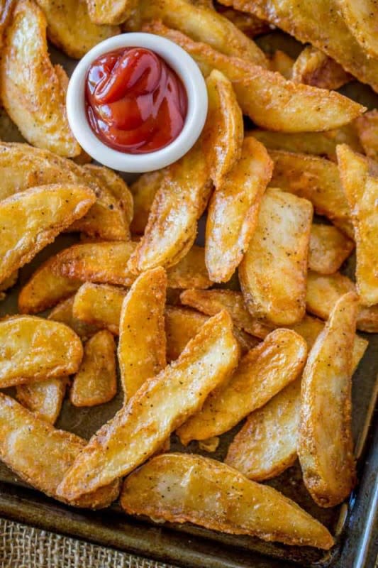 <p>Dinner Then Dessert</p><p>KFC Potato Wedges are lightly battered in a thin KFC chicken-flavored seasoning and double-fried until super crispy on the outside and fluffy on the inside.</p><p><strong>Get the recipe: </strong><a href="https://dinnerthendessert.com/kfc-potato-wedges/" rel="nofollow noopener" target="_blank" data-ylk="slk:KFC Potato Wedges;elm:context_link;itc:0;sec:content-canvas" class="link "><strong>KFC Potato Wedges</strong></a></p>