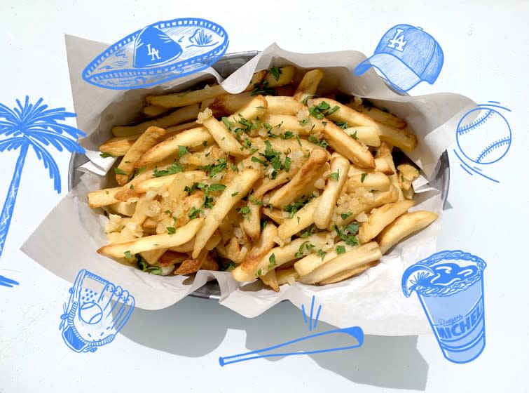 garlic fries in a basket surrounded by illustrations of dodger memorabilia