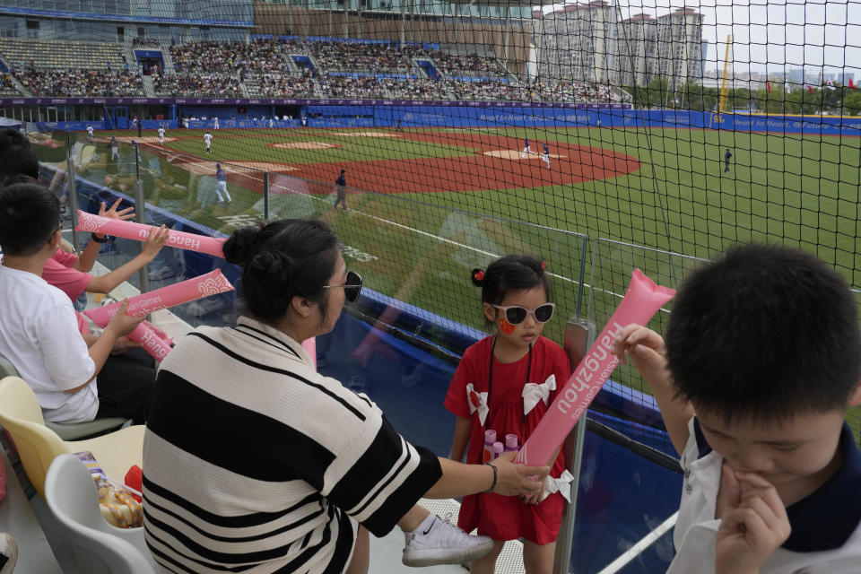 A child wearing Chinese national flag decal attend a stage group round B Baseball Men game between Taiwan and Hong Kong for the 19th Asian Games in Hangzhou, China on Tuesday, Oct. 3, 2023. At the Asian Games China has been going out of its way to be welcoming to the Taiwanese athletes, as it pursues a two-pronged strategy with the goal of taking over the island, which involves both wooing its people while threatening it militarily. (AP Photo/Ng Han Guan)