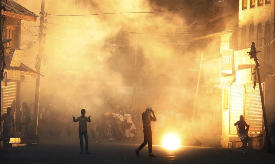 <p>Kashmiri Muslim protesters shout slogans as a tear smoke shell explods near them during clashes between police and protesters in Srinagar, the summer capital of Indian Kashmir, Aug. 31, 2016. (Photo: FAROOQ KHAN/EPA)</p>