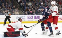 Carolina Hurricanes' Petr Mrazek, left, of the Czech Republic, makes a save as teammate Trevor van Riemsdyk, right, and Columbus Blue Jackets' Eric Robinson looks for a rebound during the second period of an NHL hockey game Thursday, Jan. 16, 2020, in Columbus, Ohio. (AP Photo/Jay LaPrete)