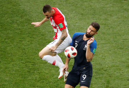 Croatia's Marcelo Brozovic in action with France's Olivier Giroud. REUTERS/Christian Hartmann