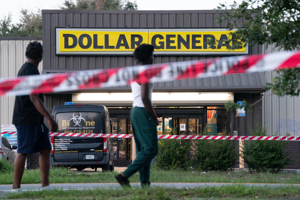 Pedestrians walk past a Dollar General store.