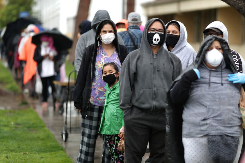 People queue to pick up fresh food at a Los Angeles Regional Food Bank giveaway of 2,000 boxes of groceries, as the spread of the coronavirus disease (COVID-19) continues, in Los Angeles