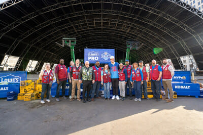 Drake Maye and Lowe’s Red Vest Associates at the 2024 NFL Draft Stage Build