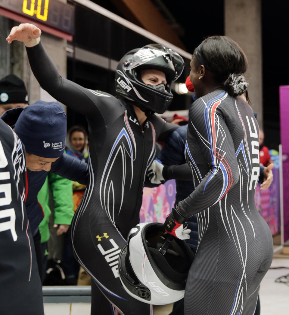 The team from the United States USA-2, piloted by Jamie Greubel with brakeman Aja Evans, hug each other after their bronze medal finish during the women's bobsled competition at the 2014 Winter Olympics, Wednesday, Feb. 19, 2014, in Krasnaya Polyana, Russia. (AP Photo/Jae C. Hong)