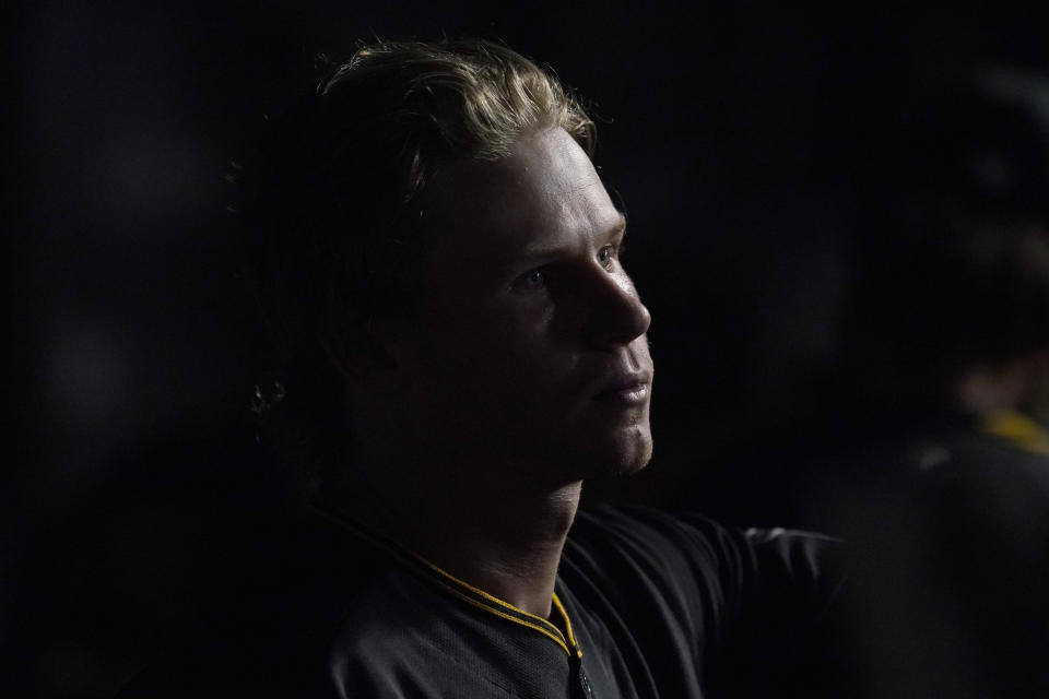 Chicago area native, Pittsburgh Pirates' Jack Suwinski, looks out of the dugout after playing for the first time in Wrigley Field as a professional baseball player during the ninth inning of a baseball game against the Chicago Cubs Monday, May 16, 2022, in Chicago. The Cubs won 9-0. (AP Photo/Charles Rex Arbogast)