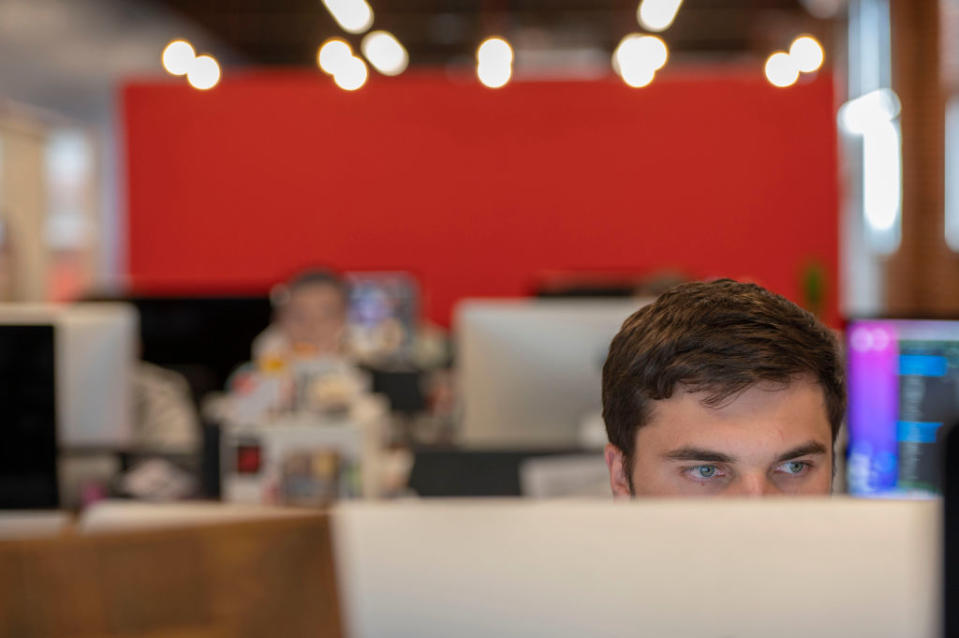 Bailey Weeks works from his office desk at Charlie Hustle headquarters on Tuesday, Sep. 6, 2022, in Kansas City. The company instituted a four-day work week for all salaried employees in its main office.<span class="copyright">Emily Curiel—The Kansas City Star/Tribune News Service/Getty Images</span>